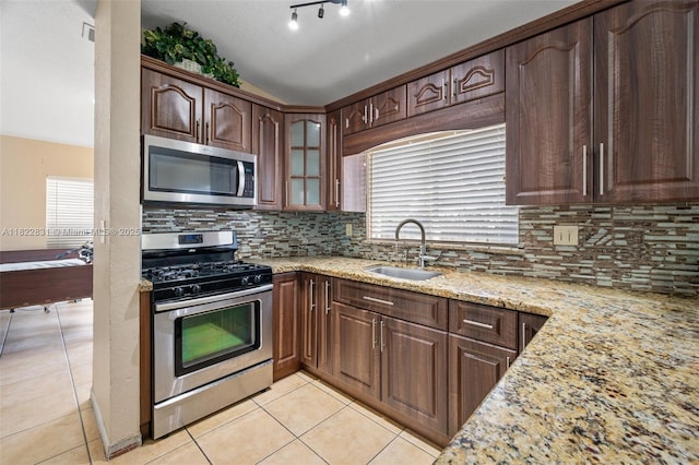 13557 SW 287th Ln, Homestead, FL 33033 - kitchen featuring stainless steel appliances, light stone countertops, light tile patterned flooring, healthy amount of natural light, and vaulted ceiling