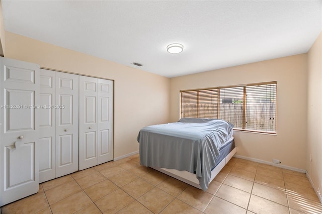13557 SW 287th Ln, Homestead, FL 33033 - bedroom featuring light tile patterned flooring and a closet
