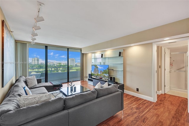 20225 NE 34th Ct Unit 1014, Aventura, FL 33180 - living area with rail lighting, wood finished floors, and a wall of windows