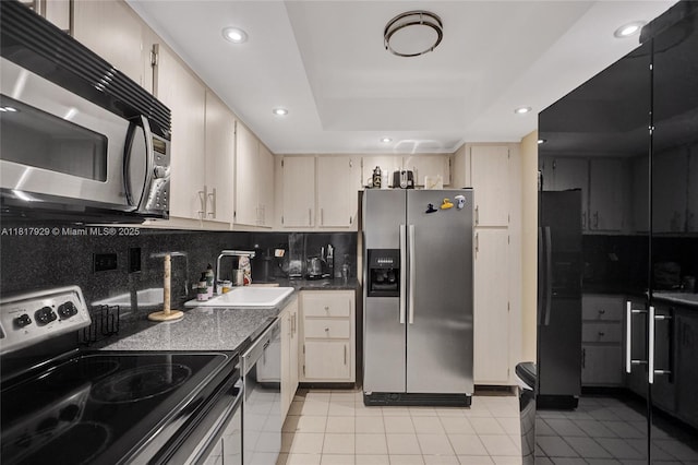 20225 NE 34th Ct Unit 1014, Aventura, FL 33180 - kitchen featuring appliances with stainless steel finishes, light tile patterned floors, a tray ceiling, backsplash, and recessed lighting