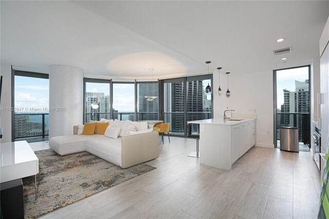 45 SW 9th St Unit 3403, Miami, FL 33130 - living area featuring a wall of windows, light wood-style floors, a city view, and recessed lighting