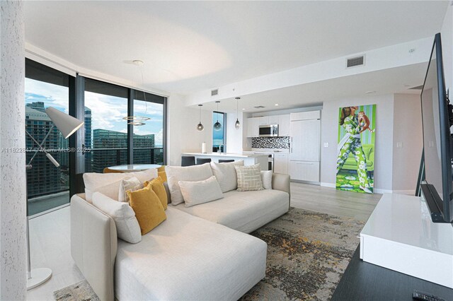 45 SW 9th St Unit 3403, Miami, FL 33130 - living room featuring floor to ceiling windows and light wood-type flooring