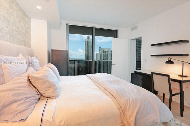 45 SW 9th St Unit 3403, Miami, FL 33130 - bedroom with wood finished floors, access to exterior, and a view of city