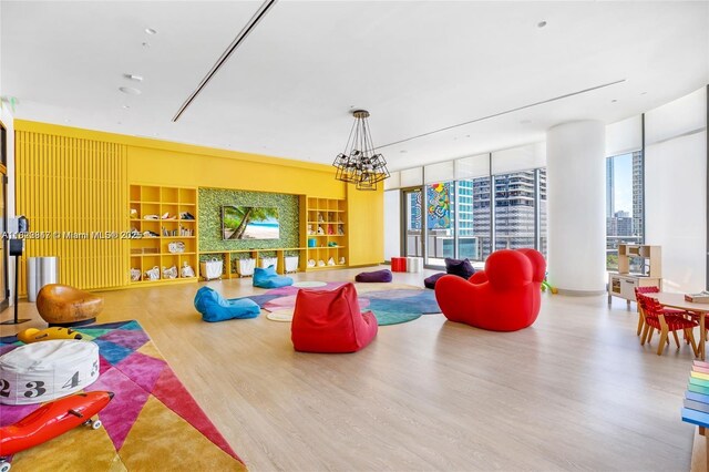 45 SW 9th St Unit 3403, Miami, FL 33130 - game room featuring wood finished floors, plenty of natural light, and a chandelier