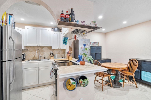 3032 Coral Ridge Dr Unit 217C, Coral Springs, FL 33065 - kitchen with stainless steel appliances, recessed lighting, tasteful backsplash, light tile patterned floors, and white cabinets