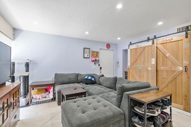 3032 Coral Ridge Dr Unit 217C, Coral Springs, FL 33065 - living room with a barn door, a textured ceiling, recessed lighting, and light tile patterned flooring