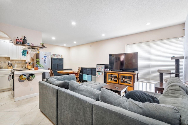 3032 Coral Ridge Dr Unit 217C, Coral Springs, FL 33065 - living area featuring light tile patterned floors, recessed lighting, arched walkways, and a textured ceiling