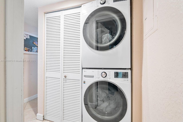 3032 Coral Ridge Dr Unit 217C, Coral Springs, FL 33065 - laundry room with estacked washer and dryer and light tile patterned floors