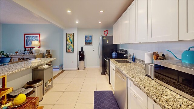 11111 Biscayne Blvd Unit 2G, Miami, FL 33181 - kitchen featuring stainless steel appliances, backsplash, recessed lighting, white cabinetry, and light stone countertops