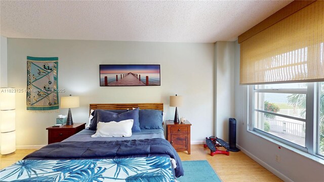 11111 Biscayne Blvd Unit 2G, Miami, FL 33181 - bedroom featuring wood finished floors and a textured ceiling