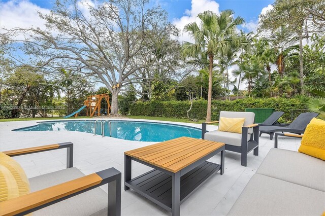 10361 SW 119th St, Miami, FL 33176 - view of pool featuring an outdoor hangout area, a patio area, a playground, and a fenced backyard