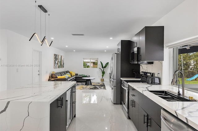 10361 SW 119th St, Miami, FL 33176 - kitchen with stainless steel appliances, dark cabinetry, pendant lighting, light stone countertops, and open floor plan