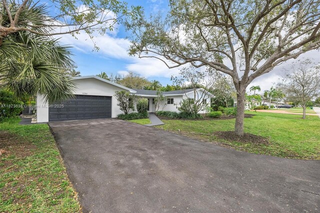 10361 SW 119th St, Miami, FL 33176 - view of front of property with asphalt driveway, a garage, a front lawn, and stucco siding