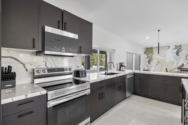 10361 SW 119th St, Miami, FL 33176 - kitchen with appliances with stainless steel finishes, decorative backsplash, light stone countertops, recessed lighting, and dark cabinetry