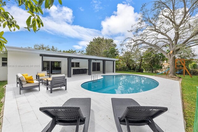 10361 SW 119th St, Miami, FL 33176 - swimming pool with a patio area, an outdoor living space, and a playground