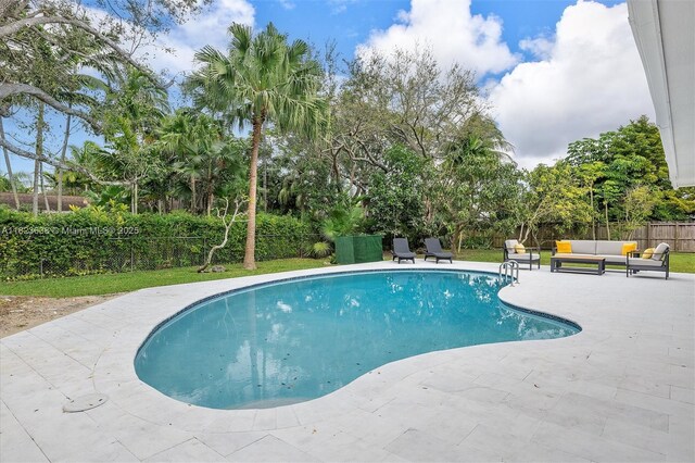 10361 SW 119th St, Miami, FL 33176 - view of pool featuring an outdoor hangout area, a patio area, a fenced backyard, and view of wooded area