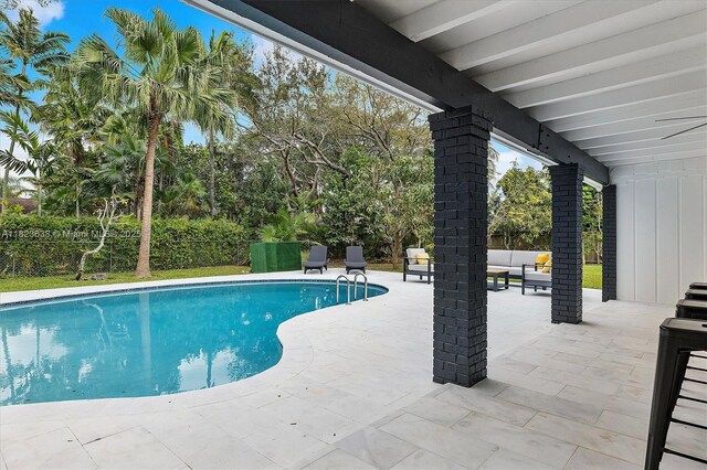 10361 SW 119th St, Miami, FL 33176 - view of swimming pool with a patio area, a fenced backyard, and view of wooded area