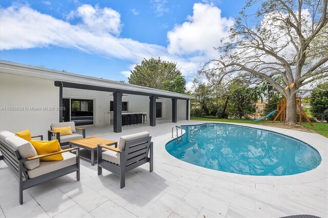 10361 SW 119th St, Miami, FL 33176 - outdoor pool featuring a patio, an outdoor living space, and a playground