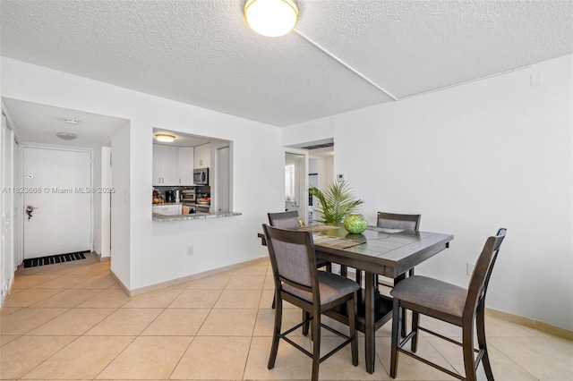 3731 N Country Club Dr Unit 2023, Aventura, FL 33180 - dining area featuring a textured ceiling and light tile patterned floors