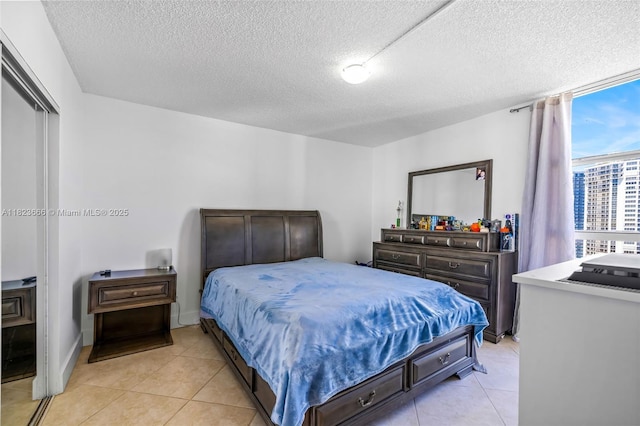 3731 N Country Club Dr Unit 2023, Aventura, FL 33180 - bedroom with a textured ceiling and light tile patterned floors