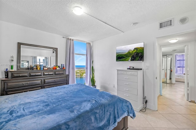 3731 N Country Club Dr Unit 2023, Aventura, FL 33180 - bedroom with a textured ceiling and light tile patterned floors