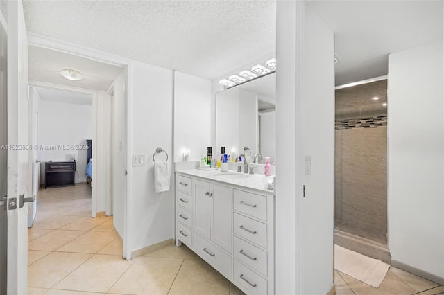 3731 N Country Club Dr Unit 2023, Aventura, FL 33180 - full bathroom featuring tile patterned flooring, vanity, a tile shower, a textured ceiling, and ensuite bath