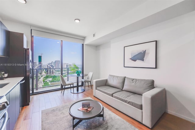 398 NE 5th St Unit 2407, Miami, FL 33132 - living room with light wood-style floors, a view of city, recessed lighting, and expansive windows