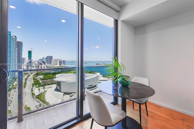 398 NE 5th St Unit 2407, Miami, FL 33132 - dining room featuring plenty of natural light, a city view, wood finished floors, and a water view
