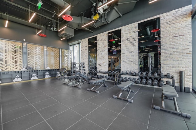 398 NE 5th St Unit 2407, Miami, FL 33132 - workout area with a towering ceiling and brick wall