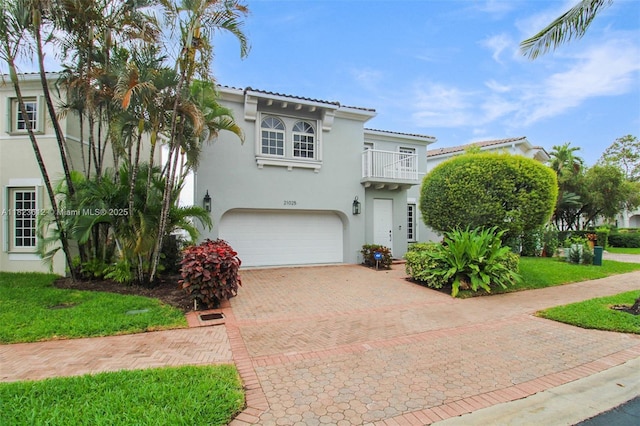 21025 NE 31st Ave, Aventura, FL 33180 - mediterranean / spanish-style home with a balcony, an attached garage, stucco siding, decorative driveway, and a tiled roof