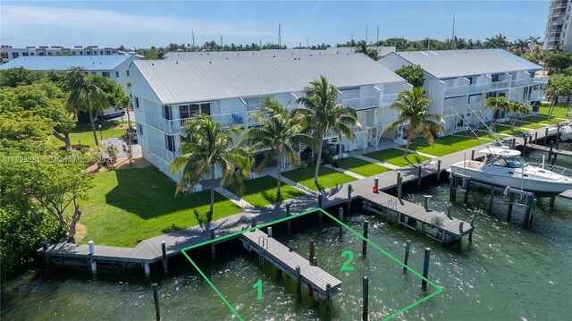 95 Coco Plum Dr Unit 1A, Marathon, FL 33050 - dock featuring a yard, a water view, and boat lift