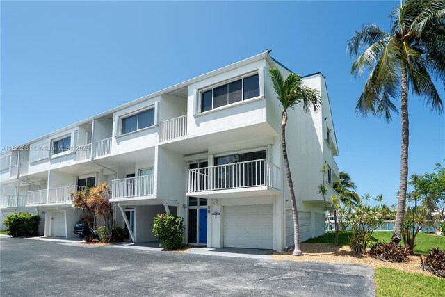 95 Coco Plum Dr Unit 1A, Marathon, FL 33050 - view of front of home with stucco siding and a garage