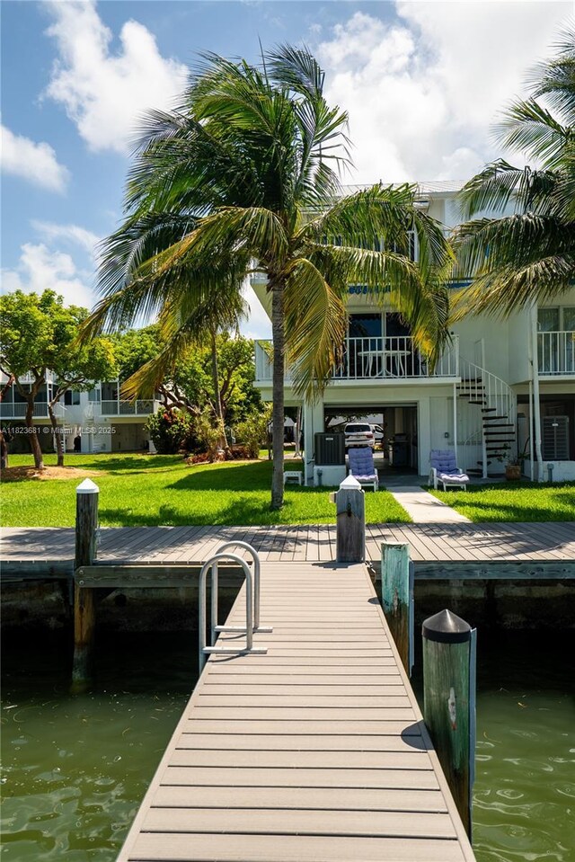 95 Coco Plum Dr Unit 1A, Marathon, FL 33050 - dock with a water view, stairway, and a lawn