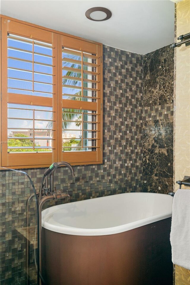 95 Coco Plum Dr Unit 1A, Marathon, FL 33050 - bathroom featuring a freestanding tub and tile walls