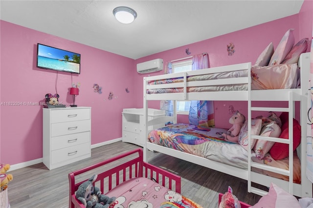 117 Ronald Rd, West Park, FL 33023 - bedroom featuring a wall unit AC and wood finished floors