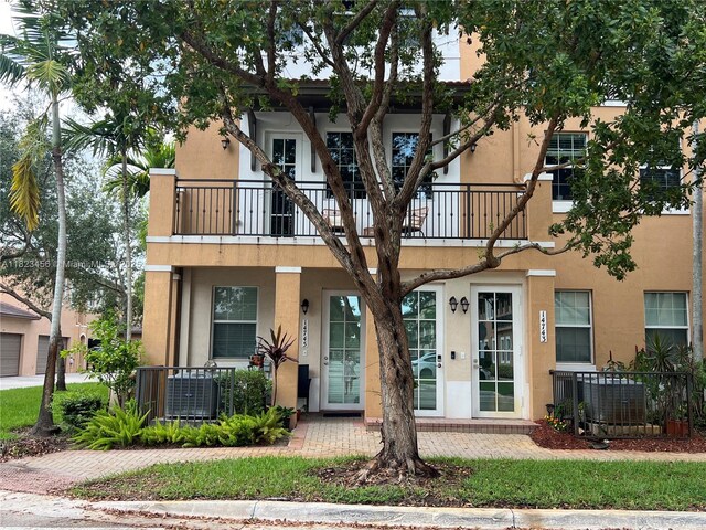 14745 SW 9th St Unit 3109, Pembroke Pines, FL 33027 - view of property with a balcony and stucco siding
