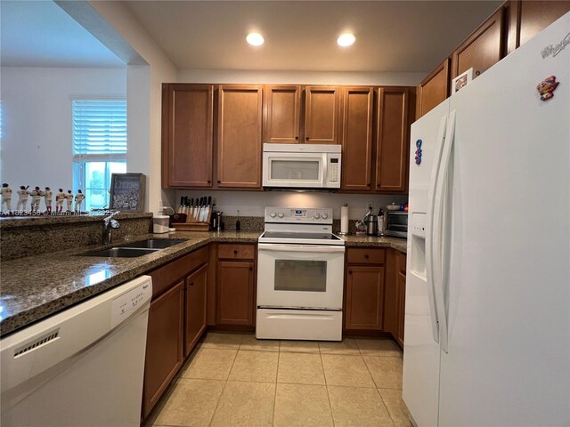 14745 SW 9th St Unit 3109, Pembroke Pines, FL 33027 - kitchen with white appliances, light tile patterned flooring, dark stone counters, recessed lighting, and brown cabinetry