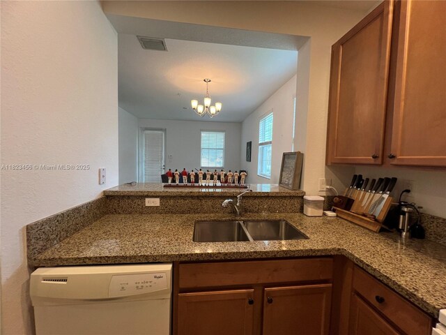 14745 SW 9th St Unit 3109, Pembroke Pines, FL 33027 - kitchen featuring dishwasher, stone counters, a peninsula, a chandelier, and brown cabinetry