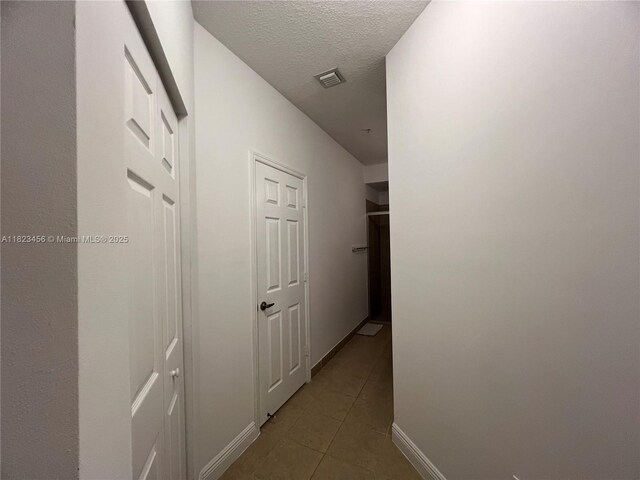 14745 SW 9th St Unit 3109, Pembroke Pines, FL 33027 - corridor featuring tile patterned flooring and a textured ceiling