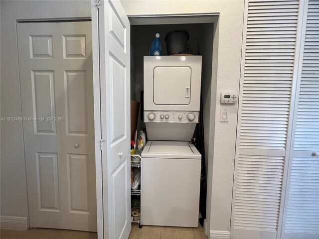 14745 SW 9th St Unit 3109, Pembroke Pines, FL 33027 - laundry room featuring stacked washer and clothes dryer and light tile patterned floors