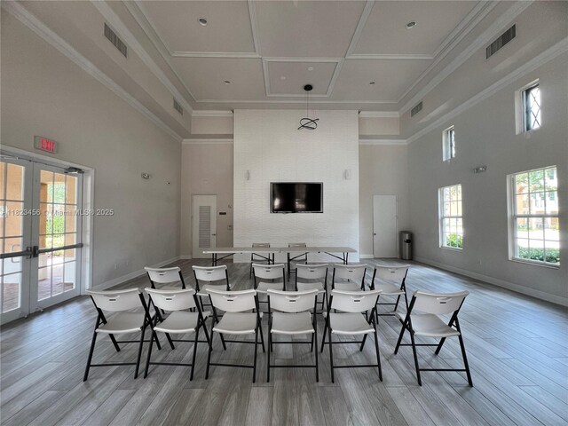 14745 SW 9th St Unit 3109, Pembroke Pines, FL 33027 - dining room with a towering ceiling, french doors, light wood-style floors, and crown molding