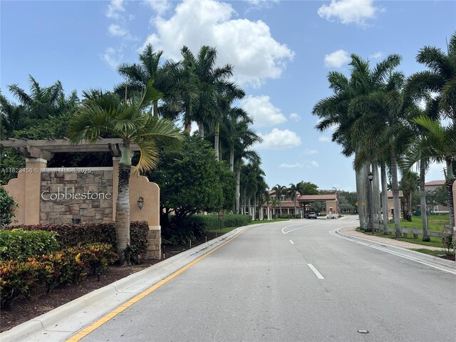 14745 SW 9th St Unit 3109, Pembroke Pines, FL 33027 - view of asphalt road with curbs and street lights