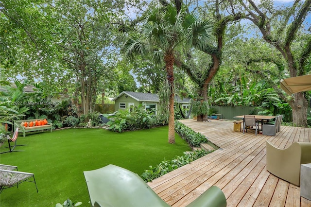 842 NW 9th Ct, Miami, FL 33136 - view of grassy yard featuring outdoor dining area, a wooden deck, and an outbuilding