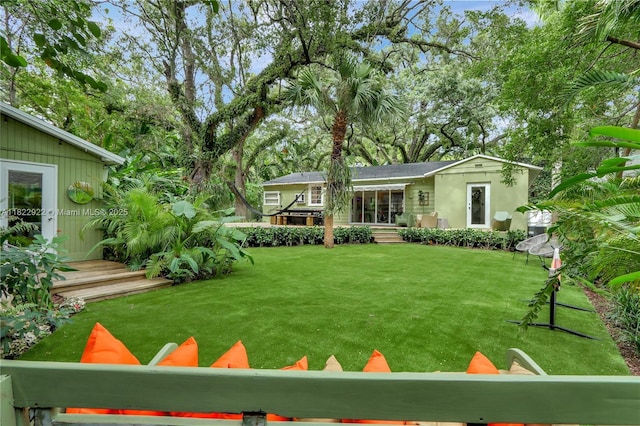 842 NW 9th Ct, Miami, FL 33136 - view of grassy yard featuring a wooden deck