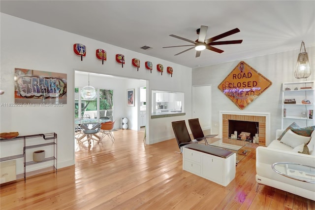 842 NW 9th Ct, Miami, FL 33136 - living area featuring ceiling fan, light wood-type flooring, and a brick fireplace