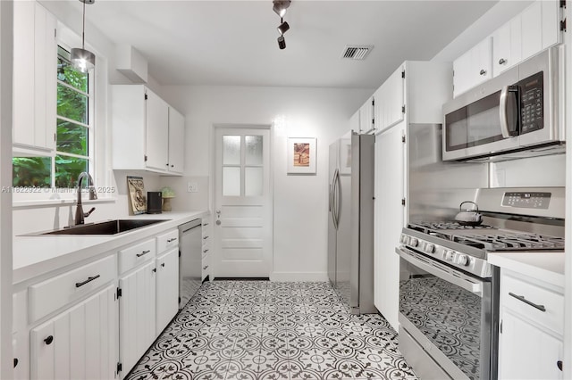 842 NW 9th Ct, Miami, FL 33136 - kitchen with appliances with stainless steel finishes, white cabinetry, and light countertops