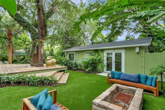 842 NW 9th Ct, Miami, FL 33136 - view of grassy yard with french doors and a wooden deck