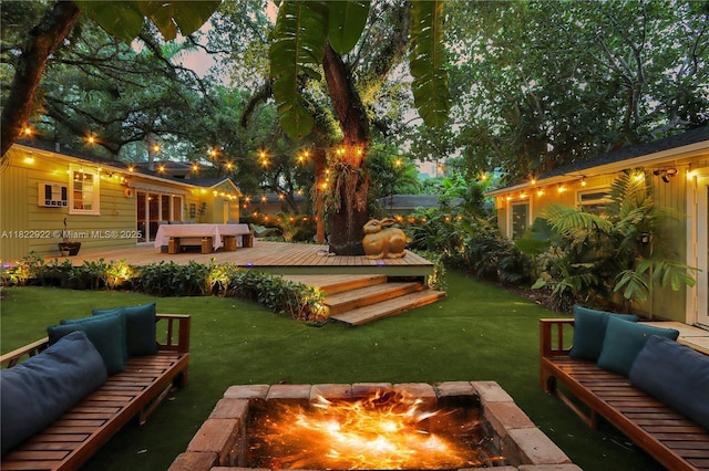 842 NW 9th Ct, Miami, FL 33136 - view of grassy yard with an outdoor living space with a fire pit and a deck