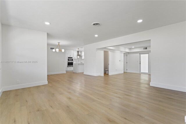 5401 Fillmore St, Hollywood, FL 33021 - unfurnished living room with a chandelier, recessed lighting, and light wood-style flooring