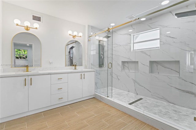 5401 Fillmore St, Hollywood, FL 33021 - bathroom featuring a marble finish shower, double vanity, wood finished floors, and recessed lighting